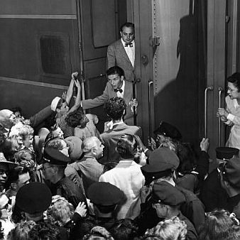 Frank Sinatra being greeted by fans at Pasadena, CA train station, August 1943.