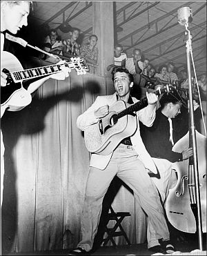 July 31, 1955. Elvis during concert at Tampa, FL’s Ft. Homer Hesterly Armory. (Photo, William ‘Red’ Robertson).