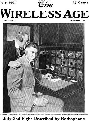 Boxer Jack Dempsey, being introduced to new “radiophone” technology, appears on cover of “The Wireless Age” magazine, July 1921.