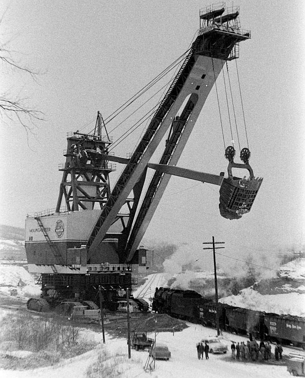 The Mountaineer shovel, from a Life magazine photo in the 1950s, shows the colossal size of this earth mover relative to nearby vehicles, locomotive, and group of workmen.