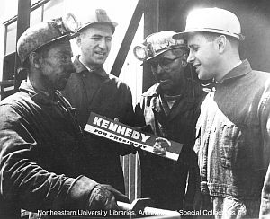 April 28, 1960. JFK campaigner, 'Bunny' Solomon (North-eastern University, MA, top center) with coal miners in Tioga, WW, displaying "Kennedy For President” bumper sticker.