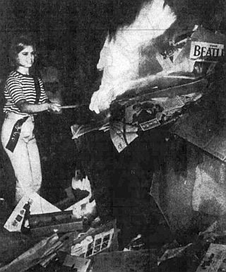 August 15, 1966: UPI wire photo showing Donna Woods of Longview, Texas applying torch to pile of Beatles material, ending a 10-day “Burn the Beatles” campaign.