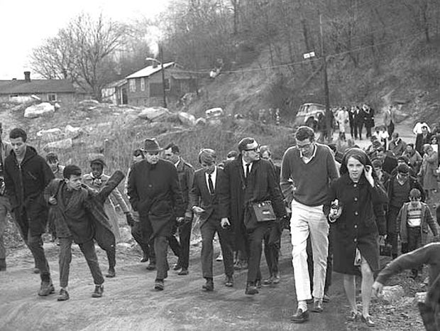 February 1968: Robert F. Kennedy, center, looking down, no top coat, with following crowd of onlookers, staff and media, as he makes his tour of Eastern Kentucky, here on Liberty St., Hazard, KY, photo, Paul Gordon.