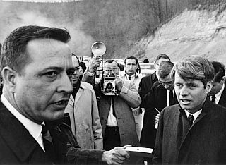 Senator Robert F. Kennedy talking with strip mine owner Bill Sturgill at the Yellow Creek mine site in Knott County, Kentucky, February 1968.
