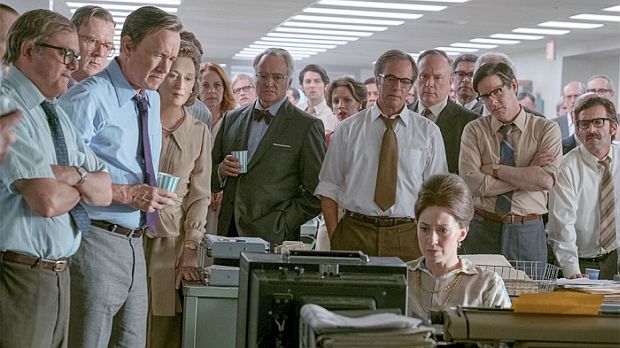 Scene from Steven Spielberg's 2017-18 film, ‘The Post’, showing, at left, Ben Bradlee (Hanks, w/cup), Kay Graham (Streep) next to him, and Meg Greenfield, seated (Carrie Coon), watching news on table-top TV set in the Washington Post newsroom during the tense days of June 1971 as Pentagon Papers publication was being challenged by the Nixon Administration. Click for film DVD.