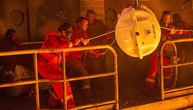 Mike, Caleb, and others attempt to deploy an emergency raft cannister, their last chance of escape from the blazing Deepwater Horizon. 