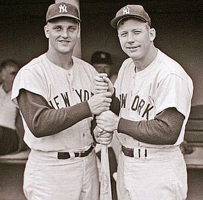 Roger Maris & Mickey Mantle of the New York Yankees playing a little “hand-over-hand” game with baseball bat to see who comes out on top.