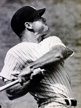 Mickey Mantle’s explosive power captured in photo as he hits one into the seats during the 1961 home run race. 