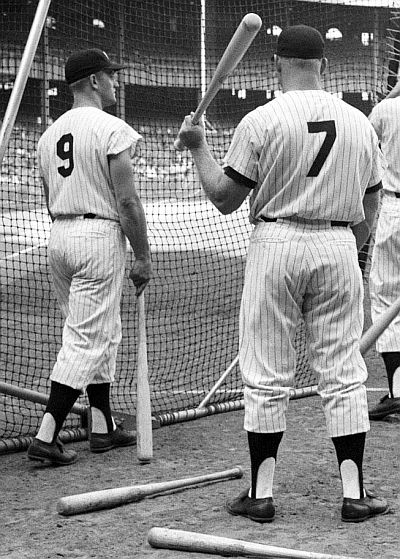 Prior year, August 1960: Roger Maris and Mickey Mantle await their turn at batting practice before a game at Yankee Stadium. In 1960, Maris hit 39 home runs (HRs) and Mantle 40.  Photo, Neil Leifer, Sports Illustrated.