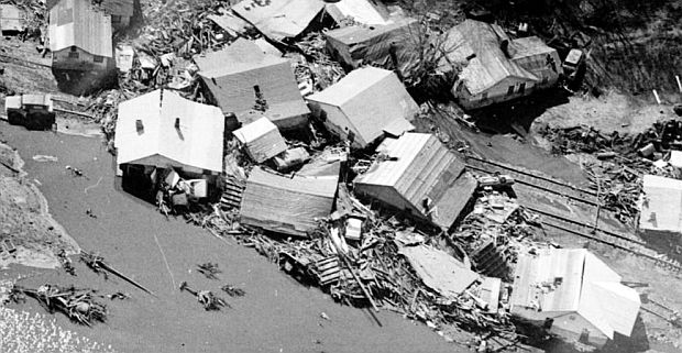 February 1972.  Aerial photograph from 'The Herald Dispatch' (Huntington, WV) captures some of the enormous damage in the Buffalo Creek valley, showing collection of homes uprooted and floated down the valley, covering roads and rail lines.