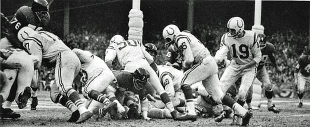 Alan Ameche, No. 35, takes hand-off from Colt quarterback Johnny Unitas, No, 19, to score on a two-yard run in the 2nd quarter after Giant’s Frank Gifford had fumbled at that end of the field, putting the Colts in the lead, 7-to-3.