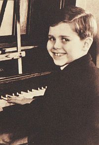 1950. Young Reggie at piano.