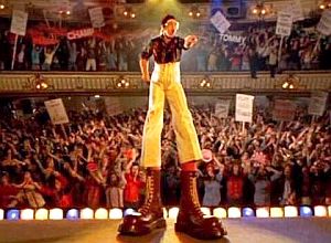 Elton John w/stilted boots in "Tommy." Click for DVD.