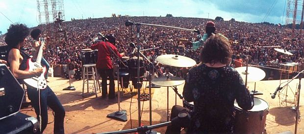 Aug 1969. Santana at Woodstock, looking out over the huge crowd – at far left front, Michael Carabello, Jose Areas on congas, David Brown on guitar, Carlos Santana, rear left, guitar, and Michael Shrieve, drums. Not shown, far left, Gregg Rolie, organ.