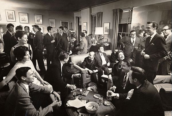At 1963 party at his home in New York, Plimpton is shown seated at lower left. Among other notables attending were: William Styron, Gore Vidal, Jonathan Miller, Truman Capote, Arthur Penn, Mario Puzo, and  Ralph Ellison. Photo, Cornell Capa.