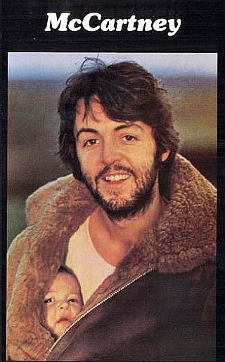 Photo from back cover of “McCartney” album, April 1970, his first solo album. Photo of he and daughter Mary, tucked inside his coat, by Linda McCartney, shot in Scotland. Click for album.
