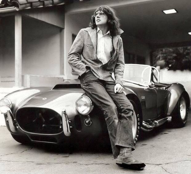 Late 1960s. Jimmy Webb in his long-hair phase, posing with his "Supersnake," high-performance, Shelby Cobra sports car.