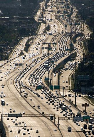 The I-10 Interstate Highway in Houston, TX illustrates the extreme, but not atypical urban interstate highway in later years built to accommodate heavy commuter use in metro areas.  Houston’s Katy Freeway, as shown here, was widened in 2008 to as many as 26 total lanes, counting six lanes of  access or frontage roads –.the world’s widest freeway. 