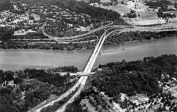 Three Sisters Bridge proposal, crossing the Potomac River from Arlington, VA, looking east into Washington, D.C., landing on river banks there (not far from Georgetown University, upper right), where it was proposed to connect with other freeway upgrades and interchanges, essentially carrying Virginia commuters into DC.
