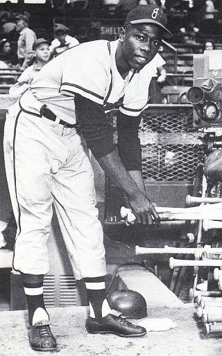 1953. Henry Aaron picking out a bat during his season with the Jacksonville Braves in Jacksonville, Florida.