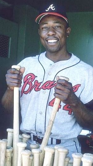 Henry Aaron picking out a bat in the prime of his career.