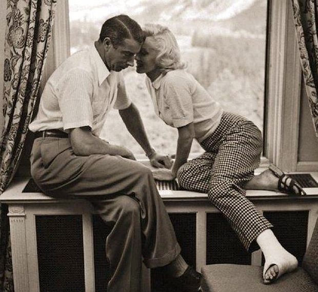 August 1953.  Joe DiMaggio and Marilyn Monroe (with ankle cast) photographed in window seat at the Banff Springs Hotel in Banff National Park, Alberta, Canada, by Look magazine photographer, John Vachon.