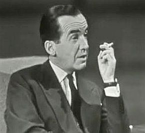 Edward R. Murrow in a familiar pose with cigarette as he interviews guests on “Person-to-Person”.