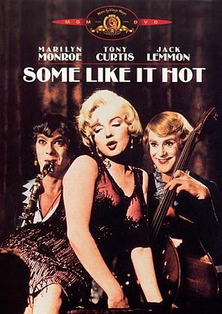 Monroe in scene with cross-dressed Curtis & Lemon in all-girl band from 1959s’ “Some Like it Hot.” Click for film.