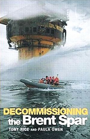 Cover of 1999 book by Tony Rice & Paula Owen, “Decommis-sioning The Brent Spar,” depicting scene from the North Sea in June 1995 as Greenpeace activists, in a motorized rubber raft, were attempting to board the Brent Spar oil storage facility – amid water-cannon fire from authorities -- in protest over the Spar’s proposed deep sea disposal. Click for book.
