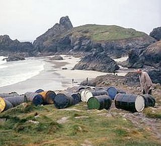 April 1967. Beach and cove at Whitesand Bay, Cornwall where empty detergent drums then still littered the area. 