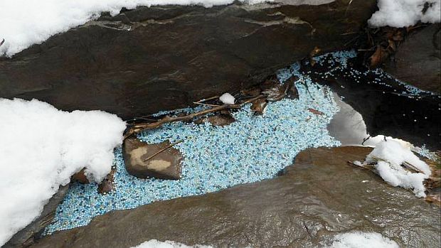 April 2018. View of plastic pellets spilled into creek in Monroe County, PA after a truck crash on I-80. The spilled pellets, shown here in a snowy creek scene, soon floated downstream from Sand Spring Run crash site to Pocono Creek more than three miles downstream. Photo, Morning Call newspaper and Bob Heil, Broadhead Water Association.