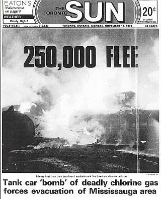 Front page of “The Toronto Sun” for November 12, 1979, with headline, photo & caption describing the fiery train wreck, toxic gas dangers, and major evacuation at Mississauga, Ontario.