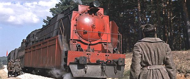 As his own train has stopped on another siding, Yuri Zhivago has wandered off through the woods hearing a waterfall, then stumbles upon an opening where Bolshevik commander Strelnikov’s armored train is parked, and is apprehended by guards suspecting him an assassin,